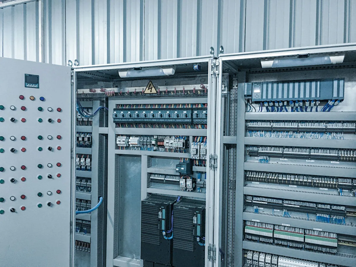 Open BELTCON control cabinets with PLC and motor control wiring